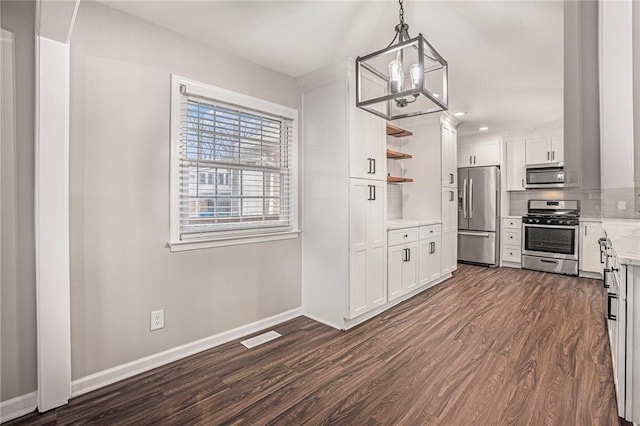 kitchen featuring dark wood-style floors, visible vents, open shelves, stainless steel appliances, and a notable chandelier