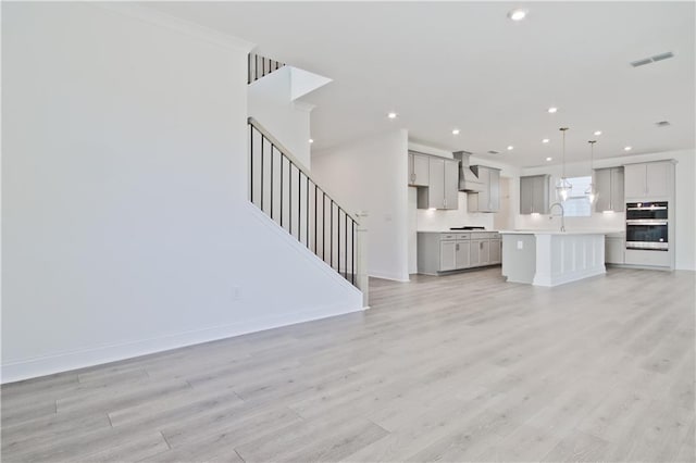 4212 Adler Cir, Buford, GA 30519 - unfurnished living room with a sink, light wood-style flooring, baseboards, visible vents, and recessed lighting