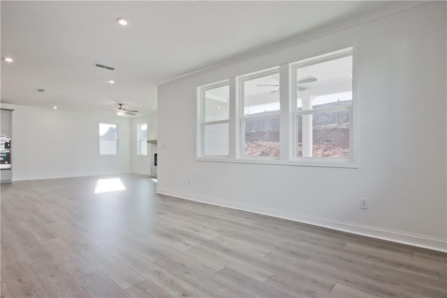 4212 Adler Cir, Buford, GA 30519 - unfurnished living room featuring light wood finished floors, baseboards, visible vents, and ceiling fan