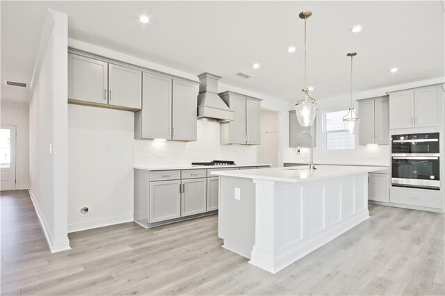 4212 Adler Cir, Buford, GA 30519 - kitchen with gray cabinetry, double oven, a sink, and custom exhaust hood
