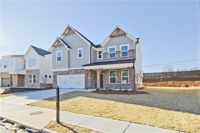 4212 Adler Cir, Buford, GA 30519 - view of front of house featuring driveway, stone siding, fence, board and batten siding, and a garage