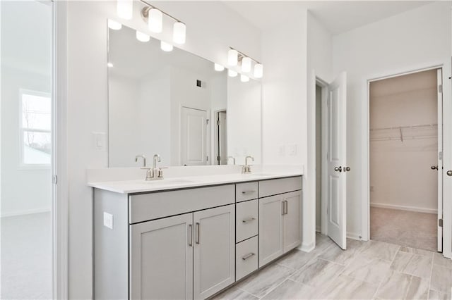 4212 Adler Cir, Buford, GA 30519 - bathroom with a spacious closet, double vanity, a sink, and visible vents