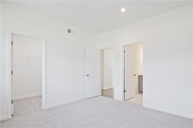 4212 Adler Cir, Buford, GA 30519 - unfurnished bedroom featuring visible vents, baseboards, recessed lighting, a spacious closet, and light colored carpet