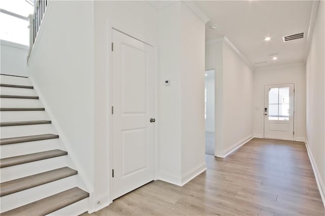 4212 Adler Cir, Buford, GA 30519 - entryway featuring stairs, visible vents, light wood-style floors, and crown molding