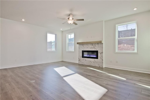 4212 Adler Cir, Buford, GA 30519 - unfurnished living room with a ceiling fan, recessed lighting, a premium fireplace, and wood finished floors