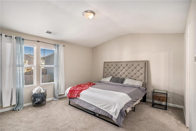 carpeted bedroom with lofted ceiling