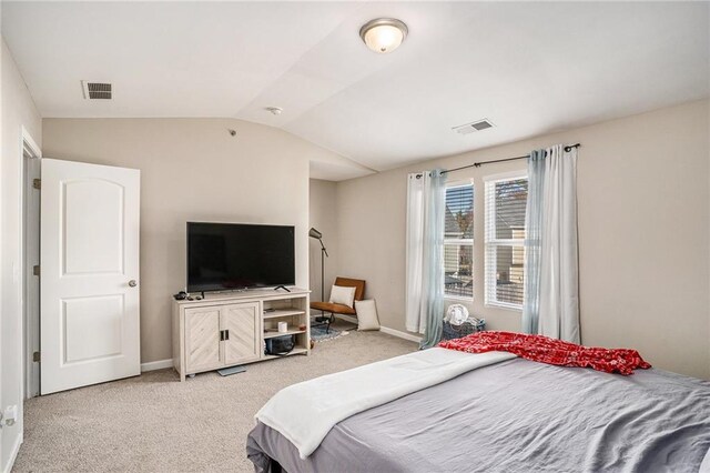 bedroom with light colored carpet and lofted ceiling