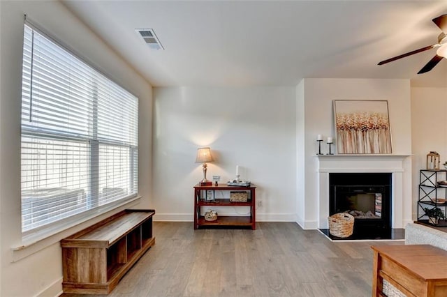 sitting room with hardwood / wood-style flooring and ceiling fan