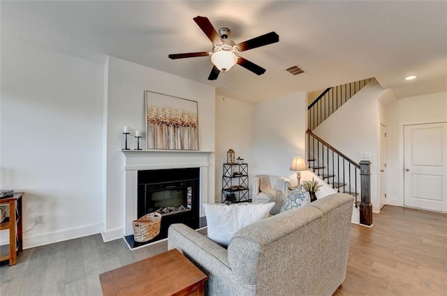 living room featuring hardwood / wood-style flooring and ceiling fan