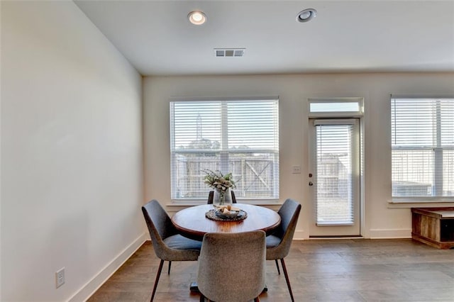 dining space with hardwood / wood-style flooring