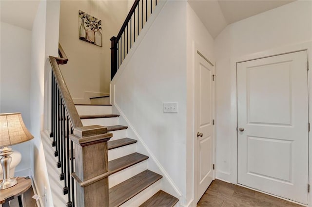 stairway featuring wood-type flooring