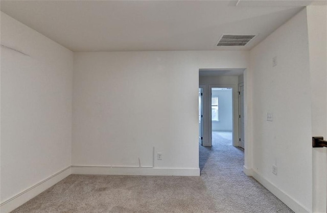 spare room featuring light colored carpet