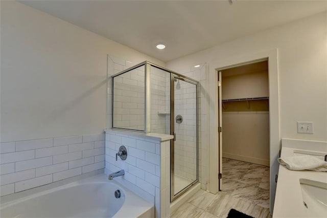 bathroom featuring plus walk in shower and vanity