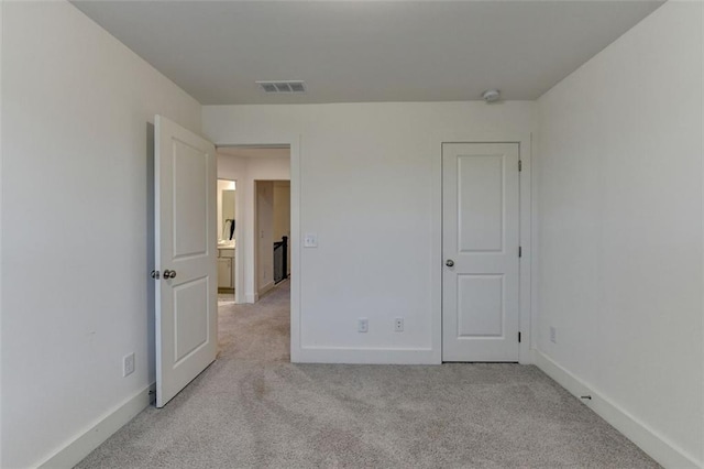 unfurnished bedroom featuring light colored carpet