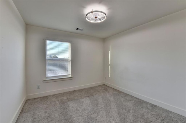 unfurnished room featuring light colored carpet