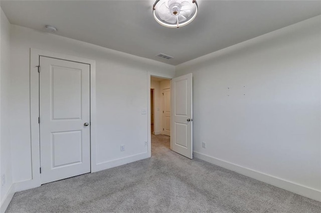 unfurnished bedroom featuring light carpet