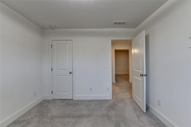 unfurnished bedroom with light colored carpet