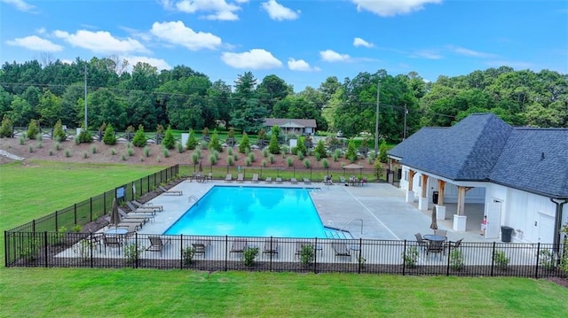 view of swimming pool featuring a lawn and a patio