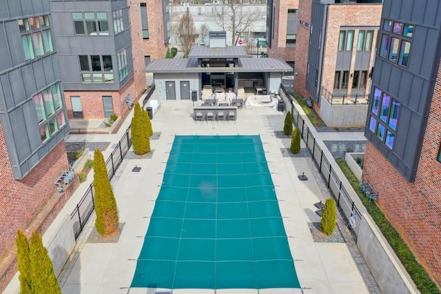 pool with fence and a patio