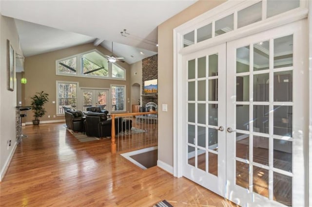 interior space featuring a fireplace, french doors, ceiling fan, and hardwood / wood-style floors