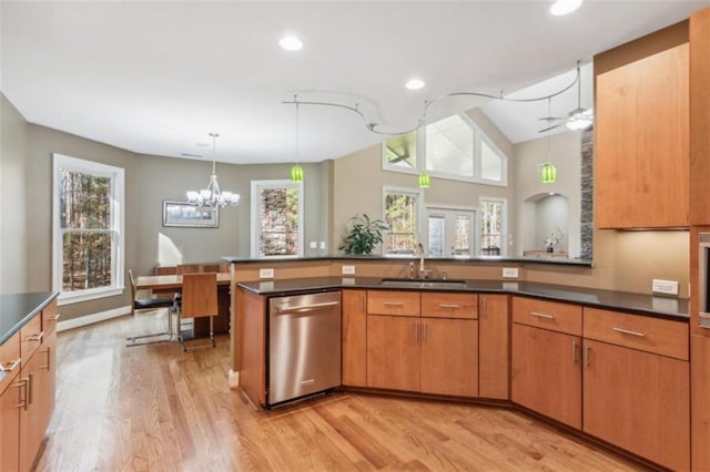 kitchen with light wood-type flooring, ceiling fan with notable chandelier, sink, pendant lighting, and dishwasher