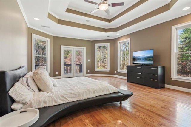 bedroom with ornamental molding, access to outside, a raised ceiling, ceiling fan, and light hardwood / wood-style floors