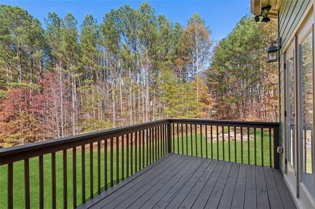 wooden terrace featuring a yard