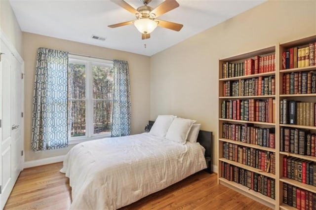 bedroom with light hardwood / wood-style floors and ceiling fan