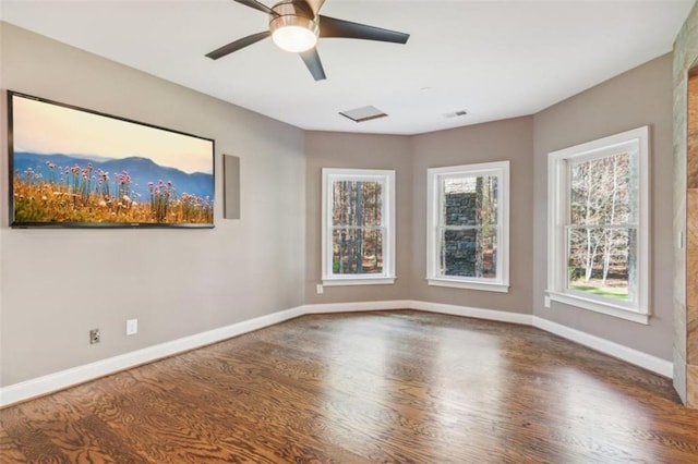 spare room featuring ceiling fan, plenty of natural light, and hardwood / wood-style floors