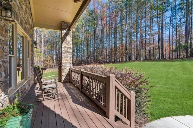 wooden terrace featuring a yard