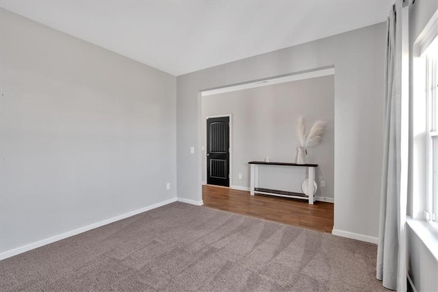 empty room with baseboards and carpet floors