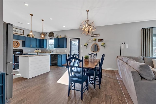 dining room with dark wood finished floors, an inviting chandelier, recessed lighting, and baseboards