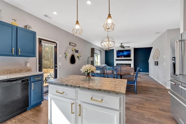 kitchen featuring blue cabinets, visible vents, open floor plan, a glass covered fireplace, and dishwasher