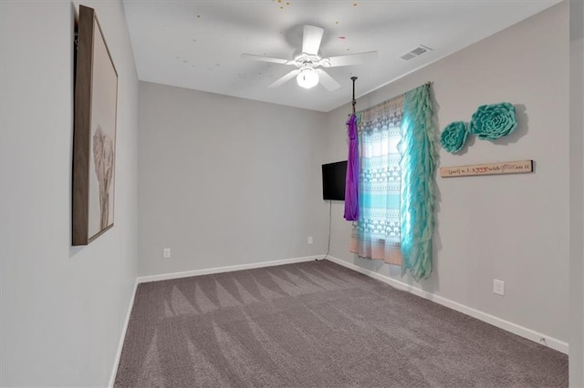 spare room featuring visible vents, baseboards, carpet, and ceiling fan