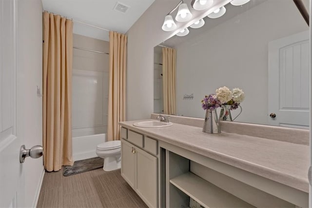 bathroom featuring visible vents, toilet, vanity, and shower / tub combo with curtain