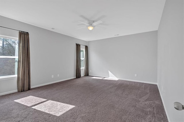 empty room with plenty of natural light, carpet, and ceiling fan