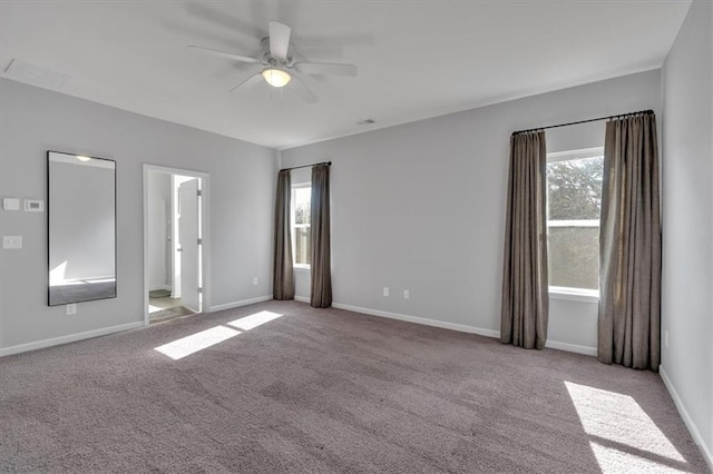 empty room featuring visible vents, baseboards, carpet floors, and ceiling fan