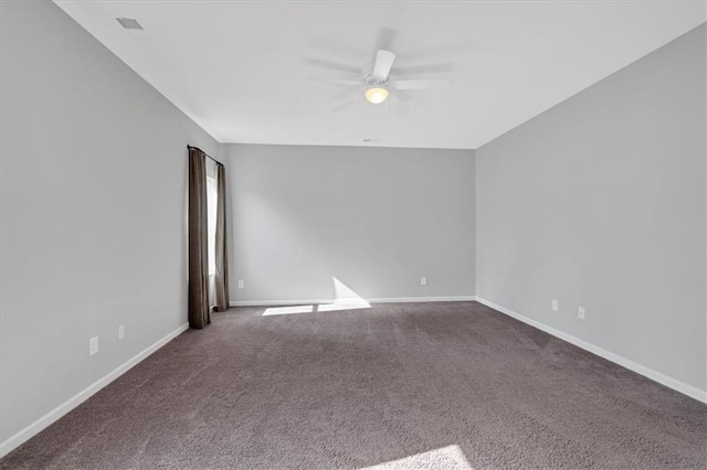 spare room featuring baseboards, ceiling fan, and carpet floors