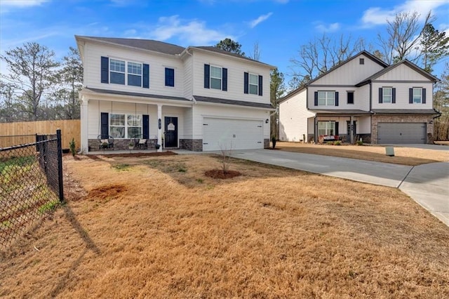 view of front facade featuring fence, concrete driveway, covered porch, stone siding, and an attached garage