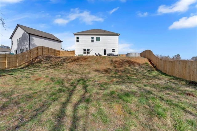 back of property with a fenced backyard