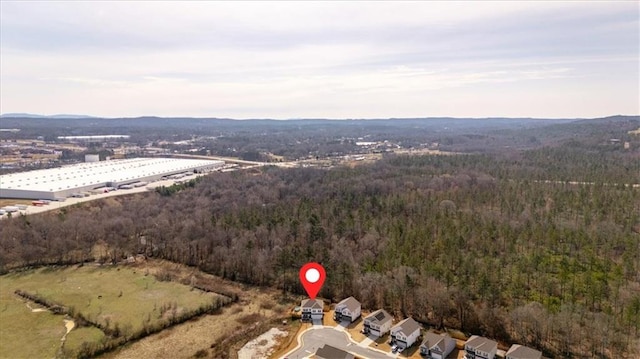 birds eye view of property featuring a view of trees