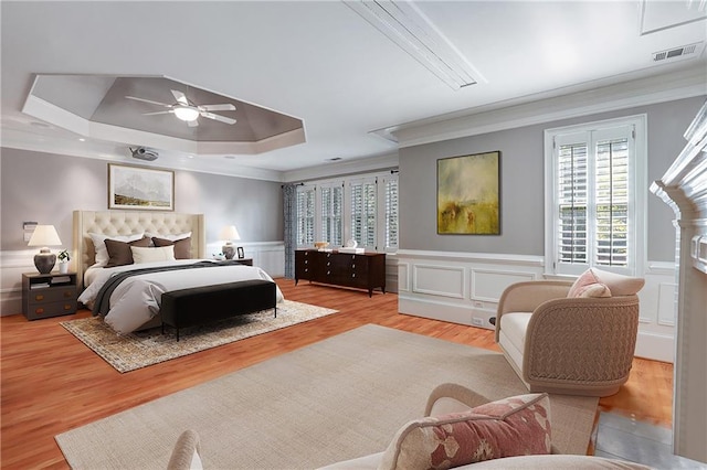 5040 Harrington Rd, Johns Creek, GA 30022 - bedroom with ornamental molding, a tray ceiling, wainscoting, wood finished floors, and a decorative wall