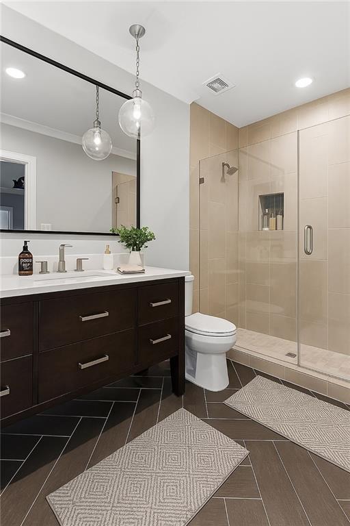 5040 Harrington Rd, Johns Creek, GA 30022 - bathroom featuring a shower stall, crown molding, vanity, toilet, and recessed lighting