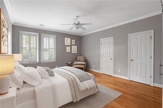5040 Harrington Rd, Johns Creek, GA 30022 - bedroom with ornamental molding, light wood-type flooring, two closets, baseboards, and ceiling fan
