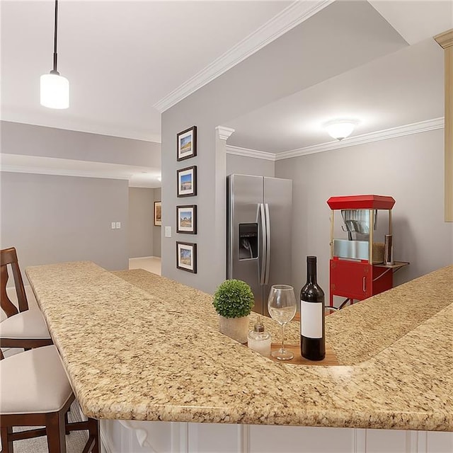 5040 Harrington Rd, Johns Creek, GA 30022 - kitchen with stainless steel fridge, crown molding, a kitchen breakfast bar, and light stone counters