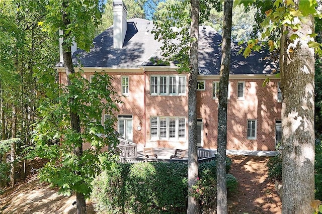5040 Harrington Rd, Johns Creek, GA 30022 - back of house with brick siding and a chimney