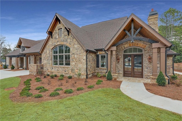 5040 Harrington Rd, Johns Creek, GA 30022 - view of front of home featuring stone siding, a chimney, a shingled roof, and french doors