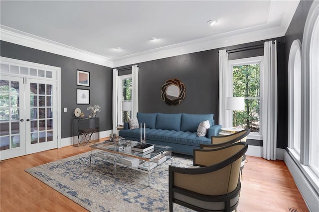5040 Harrington Rd, Johns Creek, GA 30022 - living room with healthy amount of natural light, french doors, crown molding, light wood-style floors, and baseboards
