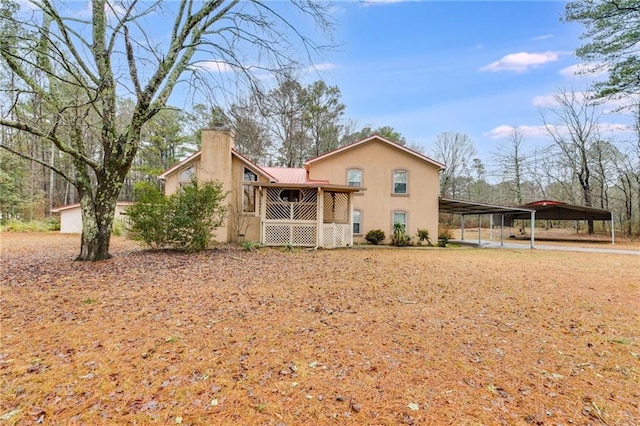 back of property featuring a carport