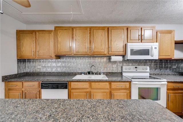 kitchen with sink, a textured ceiling, white appliances, and decorative backsplash